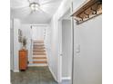 Inviting entryway with neutral walls, tiled floor, wood accents, and stairs leading to the upper level at 933 Vistavia Cir, Decatur, GA 30033