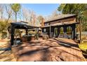 Spacious deck featuring a covered gazebo, natural surroundings and mature trees at 1435 Jay Ct, Snellville, GA 30078