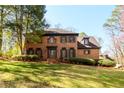 Charming two story brick home with manicured lawn and mature landscaping at 1435 Jay Ct, Snellville, GA 30078