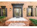 Close up of the front brick entryway with beautiful door, sidelights, and sidelight windows at 1435 Jay Ct, Snellville, GA 30078