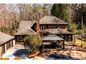Expansive back yard featuring a deck with gazebo, brick patio and natural surroundings at 1435 Jay Ct, Snellville, GA 30078