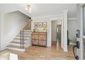 Inviting home foyer with hardwood floors, wooden staircase with iron spindles, and view to other rooms at 2958 Cravey Ne Dr, Atlanta, GA 30345