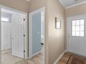 Bright hallway with entry to bathroom and bedroom, showcasing hardwood floors and neutral wall color at 740 Azalea Ave, Mcdonough, GA 30253