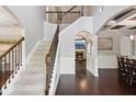 Elegant foyer showcasing a staircase with wooden handrails and a view into the adjacent dining and living spaces at 3975 Silverthorn Trce, Cumming, GA 30028