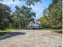 Charming two-story home with a metal roof, mature trees, and well-maintained grounds at 5809 Warren Farm Sw Rd, Powder Springs, GA 30127