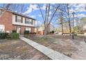 Pleasant front view of townhome with walkway and manicured shrubs at 6440 Wedgewood Trce, Tucker, GA 30084