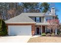 Charming two-story home featuring a brick facade, attached garage, and beautifully landscaped front yard at 3952 Rhyne Way, Smyrna, GA 30082