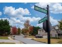Street corner view showcasing well-maintained homes with mature trees at 5825 Trailwood Ct, Suwanee, GA 30024