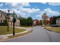 Neighborhood street view showcasing well-maintained homes and mature trees at 5825 Trailwood Ct, Suwanee, GA 30024