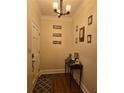 Welcoming entryway featuring hardwood floors, decorative wall art and a charming console table at 2151 Overland Way, Powder Springs, GA 30127
