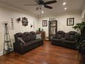 Beautiful living room featuring hardwood floors and stylish, comfortable, leather seating at 2151 Overland Way, Powder Springs, GA 30127