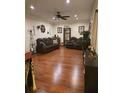 Spacious living room with hardwood floors, ceiling fan, and comfortable seating area at 2151 Overland Way, Powder Springs, GA 30127