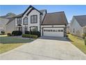 Charming two-story home featuring black and white trim, a well-manicured lawn, and an attached two-car garage at 2882 Manor Glen Ln, Suwanee, GA 30024