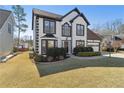 Charming two-story home featuring black and white trim, a well-manicured lawn, and an attached two-car garage at 2882 Manor Glen Ln, Suwanee, GA 30024