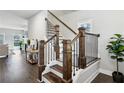 Elegant staircase with dark wood steps, iron railings, and a bright, open design at 3143 Stonegate Sw Dr, Atlanta, GA 30331