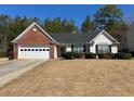 Charming single-story home with a two-car garage and meticulously manicured lawn at 50 Cold Springs Ct, Covington, GA 30016