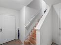 Bright entryway with a staircase featuring wood treads and a white handrail, creating a welcoming atmosphere at 1575 Ridenour Nw Pkwy # 820, Kennesaw, GA 30152