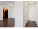 Inviting hallway with sleek, dark hardwood floors leading to a cozy kitchen area at 2479 Peachtree Ne Rd # 1703, Atlanta, GA 30305