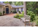 Inviting front entrance features stone pavers, a wooden bench, and landscaping adding to the curb appeal at 366 Blackland Nw Rd, Atlanta, GA 30342