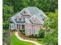 Beautiful brick home with manicured lawn and landscaping at 10275 Worthington Mnr, Suwanee, GA 30024