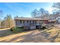 Charming ranch home featuring a spacious porch and classic architectural details on a sunny day at 1315 Woodland Sw Dr, Oxford, GA 30054