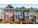 Charming townhome showcasing brick facade, varied architectural details, covered entryways, and well-maintained landscaping at 2251 Limehurst Ne Dr, Atlanta, GA 30319