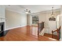 Bright living room featuring hardwood floors, fireplace, staircase, and large window providing natural light at 2251 Limehurst Ne Dr, Atlanta, GA 30319