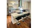 Modern kitchen with quartz countertops, stainless steel appliances and breakfast bar at 3868 Demooney Rd, Atlanta, GA 30349