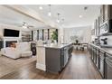 Open-concept kitchen with granite countertops, stainless steel appliances, and adjoining living space at 590 Palm Springs Cir, Fairburn, GA 30213