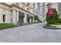 Elegant entrance to the Mayfair, with a landscaped driveway and architectural details at 199 14Th Ne St # 1704, Atlanta, GA 30309