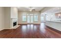 Spacious living room with hardwood floors, fireplace, ceiling fans, and access to the outdoors through French doors at 2017 Grove Field Ln, Marietta, GA 30064