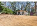 Spacious yard surrounds a white home with a storage shed in the background at 2542 Warwick Ne Cir, Atlanta, GA 30345