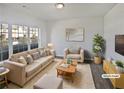 Bright, staged living room featuring a neutral color palette, cozy furnishings, and large window at 3180 Oakley Pl, Union City, GA 30291