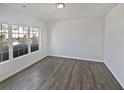 Bright living room featuring a neutral color palette, new flooring, and large window at 3180 Oakley Pl, Union City, GA 30291