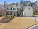 Charming two-story house with a well-maintained lawn, complemented by mature trees and tasteful landscaping at 4205 Rock Creek Dr, Cumming, GA 30028