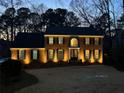 Stately brick home with manicured lawn and elegant exterior lighting at 4335 Halifax Ne Ter, Roswell, GA 30075