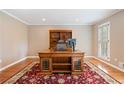 Bright office space featuring wood floors, shutters, built-in shelves, and a large desk at 4335 Halifax Ne Ter, Roswell, GA 30075