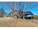 View of the property, emphasizing the convenient carport surrounded by mature trees at 1891 Donald Dr, Marietta, GA 30062