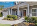 A beautiful single-Gathering home featuring a welcoming front porch with stone accents at 302 Canter Way, Woodstock, GA 30188