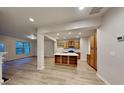 Bright, open-concept living area showcasing modern floors and seamless flow into the kitchen with island at 5107 Madeline Pl, Stone Mountain, GA 30083