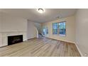 Cozy living room features a decorative fireplace, abundant natural light, and access to outdoor space at 5107 Madeline Pl, Stone Mountain, GA 30083