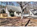 Charming home featuring stone accents, a two-car garage and well-manicured landscaping at 5532 Riverside Dr, Sugar Hill, GA 30518