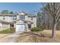 Charming exterior of a two-story home with an attached garage, complemented by a well-manicured lawn at 573 Rendezvous Rd, Acworth, GA 30102