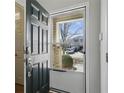 View through the open front door onto the neighborhood street with a car and other houses at 573 Rendezvous Rd, Acworth, GA 30102