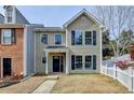 Charming two-story home with a well-manicured lawn and inviting front porch and attractive architectural details at 1284 Warsaw Rd, Roswell, GA 30076