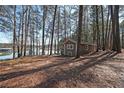 Lake house surrounded by trees leading to a serene lake view, perfect for a tranquil and nature-filled getaway at 5400 Kings Camp Rd Se B-34, Acworth, GA 30102