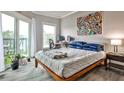 Bedroom featuring a walkout balcony, modern décor, and lots of natural light at 1 Biscayne Nw Dr # 706, Atlanta, GA 30309