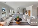 Bright living room with white furniture, large windows, and a stylish rug and decor at 3451 Meadow Grass Dr, Dacula, GA 30019