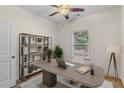 Staged home office featuring neutral carpeting, a ceiling fan, and a window for natural light at 3462 Mount Zion Rd, Stockbridge, GA 30281