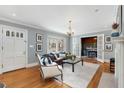 Comfortable living room with hardwood floors, a plush rug, a bay window, and French doors to study at 567 E Wesley Ne Rd, Atlanta, GA 30305